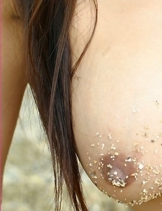 Katie Chung sits on a rock and she gets in a position that will get your mind in very freaky positions.