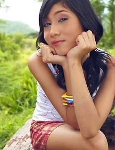 Enjoy watching stunning Yoko Hasegawa as she poses on the bench in the middle of the woods.