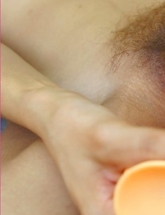 Vicky Pareemon wears a New York hat with a fisher pole in her hand. She gives a hot stare into the camera as she crosses her legs.