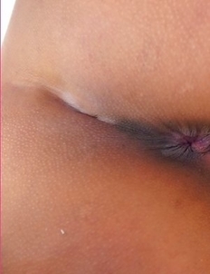 Laurence Li enters the room wearing yellow panties with a pink towel wrapped around her shoulders