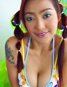 Iko Yeung loves the spotlight as she gets into her routine. She spreads her pussy lips open with her hands as she lies on the bed.