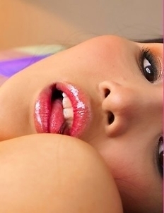 Saiko Kurosawa has features that will blow your mind. This sexy girl sits next to a window with her straight hair and white dress on.