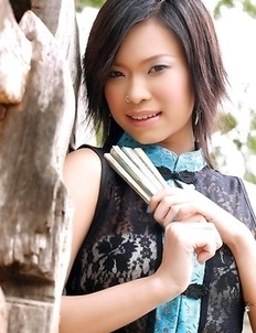 Lovely Ae Marikarn is posing next to the stables. She looks so pretty that your heart will skip a beat when you see her.