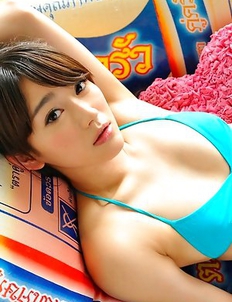 Shou Nishino in blue bath suit sits with ass up in the air