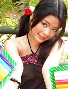 Sexy Asian babe Pang Piyatida show her upskirt and playing orange dildo