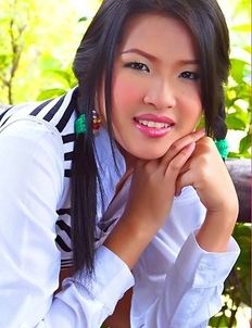 Aime Copony begins posing and she smiles for the camera while wearing a white and black top.