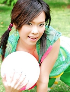 Adorable Ae Marikarn is outside and she is holding gym ball in her hands.