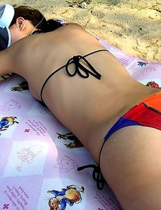 Flashing her hairy pussy on the beach