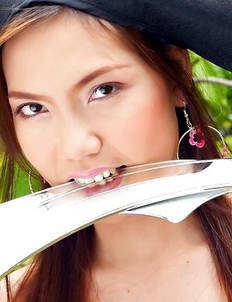 Ying Charintip in a pirate hat arranges a striptease on the street