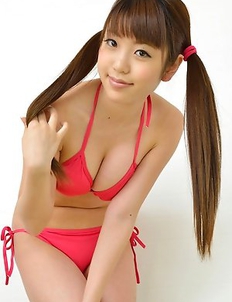 Mizuho Shiraishi with cans in pink bath suit plays with her hair