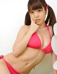 Mizuho Shiraishi with cans in pink bath suit plays with her hair