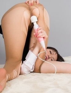 Yuma Miyazaki posing in black stockings and heels, looking seductive as fuck
